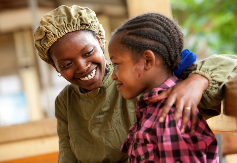 Orbis-trained integrated eye care worker, Tsehay comforts 13-year-old Asegedech, who is suffering from severe trachoma. Gamo Gofa, Ethiopia. Credit: Geoff Oliver Bugbee/Orbis