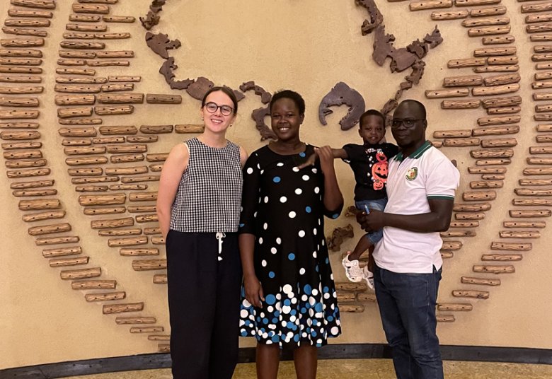 From left to right, Greta Holmes - RSTMH Grant Manager, Irene Atii, and Walter Okello, with their young child.
