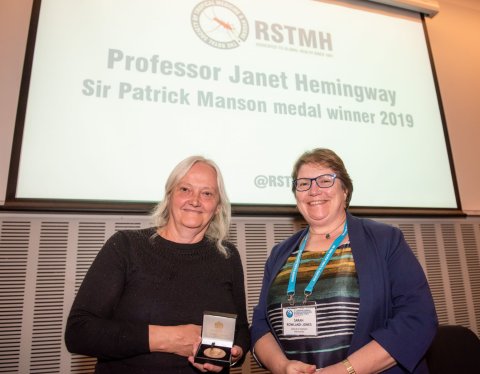 Profesor Janet Hemingway (left) receives the Manson Medal from Professor Sarah Rowland-Jones, then RSTMH President