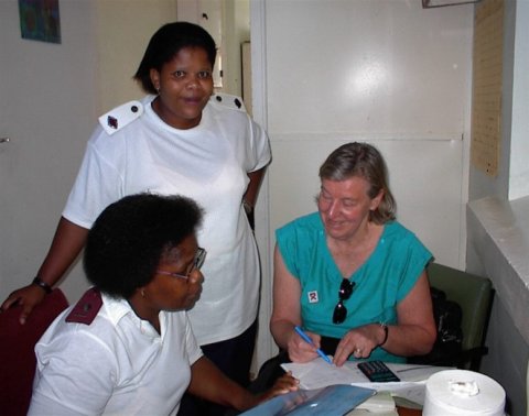 Professor Ann Ashworth with nurses in South Africa, discussing patient records.