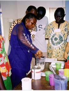 Teaching doctors and nurses in West Africa how to make up special feeds. (Credit: Ann Ashworth)