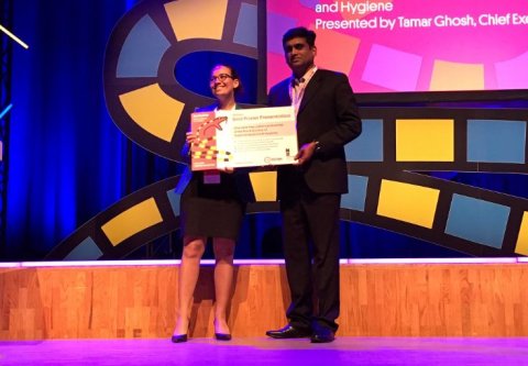 RSTMH CEO Tamar Ghosh presents the award for best poster to Jose Louies from the organisation Indian Snakes