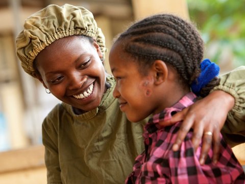 Orbis-trained integrated eye care worker, Tsehay comforts 13-year-old Asegedech, who is suffering from severe trachoma. Gamo Gofa, Ethiopia. Credit: Geoff Oliver Bugbee/Orbis