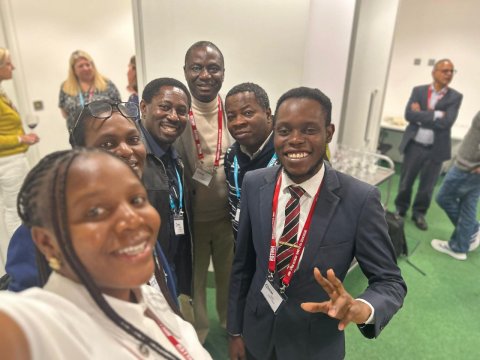 Halimat Olaniyan (far left) and Victor Femi-Lawal (far right) pictured with delegates at the Annual Meeting 2025. 